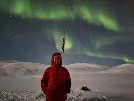 Standing in the snow under the northern lights